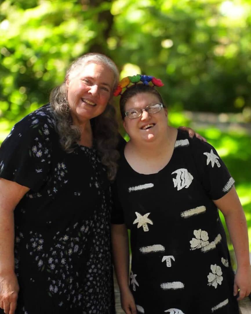 Two women sharing a joyful moment outdoors
